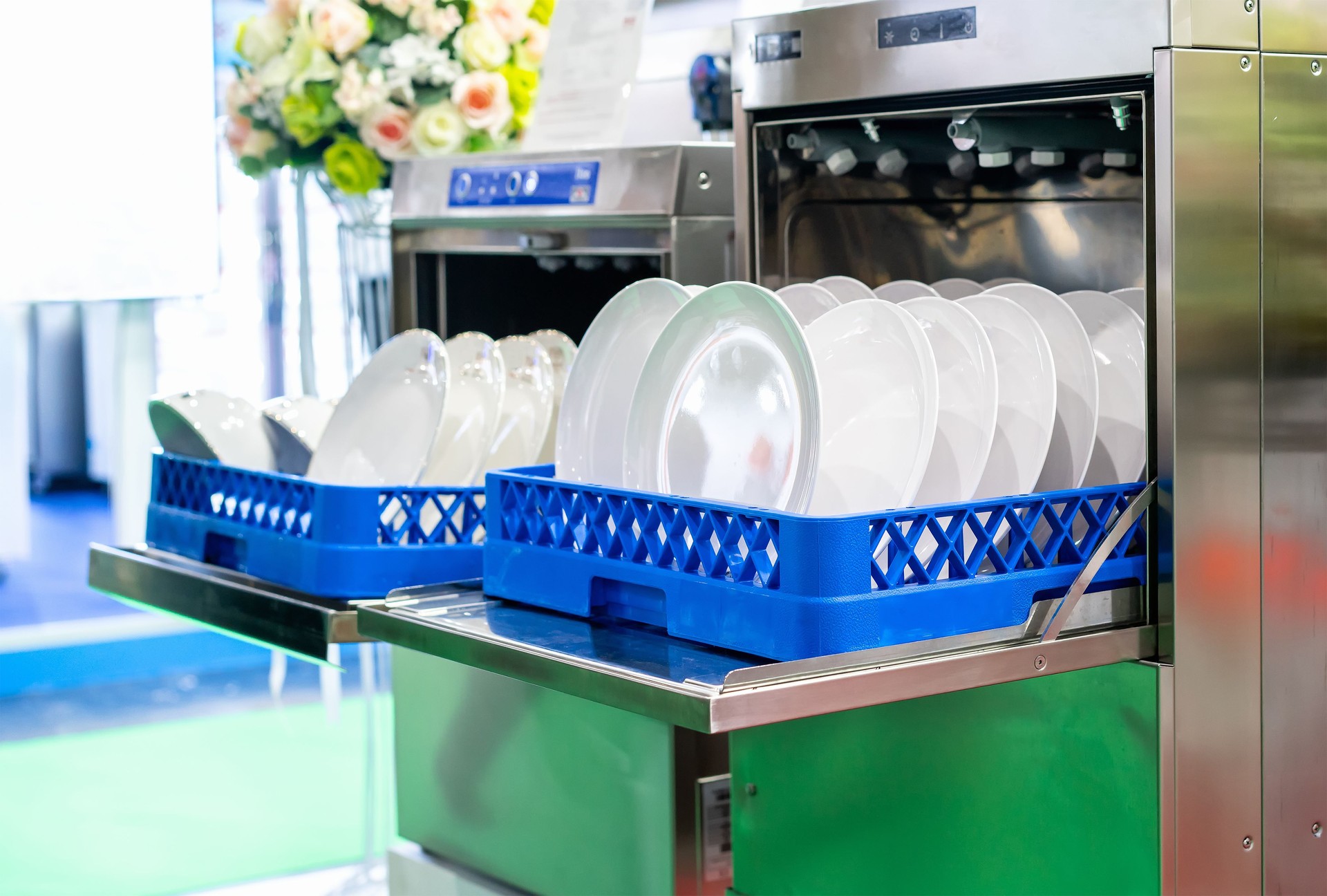 white plate on basket in automatic dishwasher machine for restaurant industrial