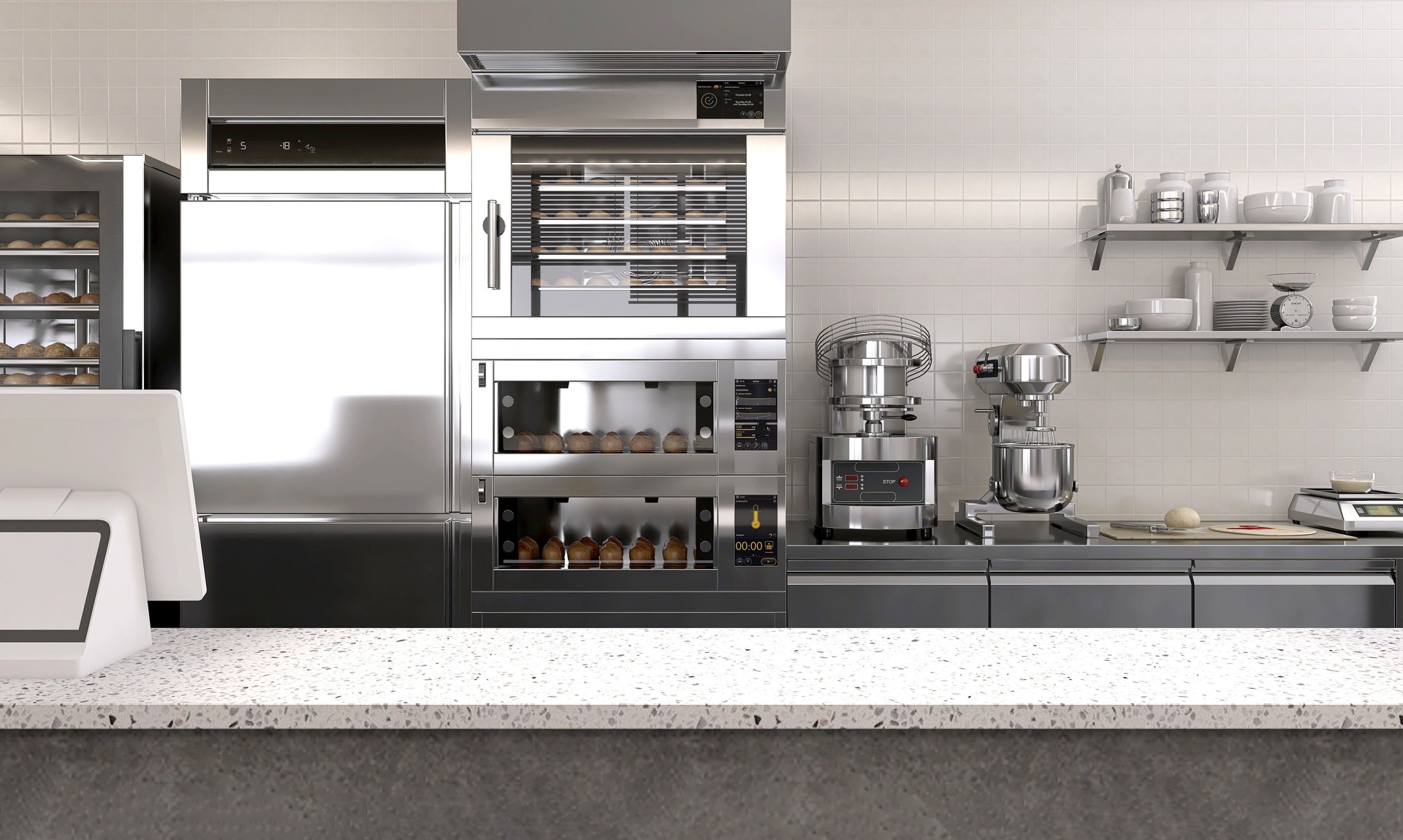 Empty clean white terrazzo top island table counter in commercial, digital cash register, professional bakery kitchen, stainless steel convection, deck oven, refrigerator, cabinet